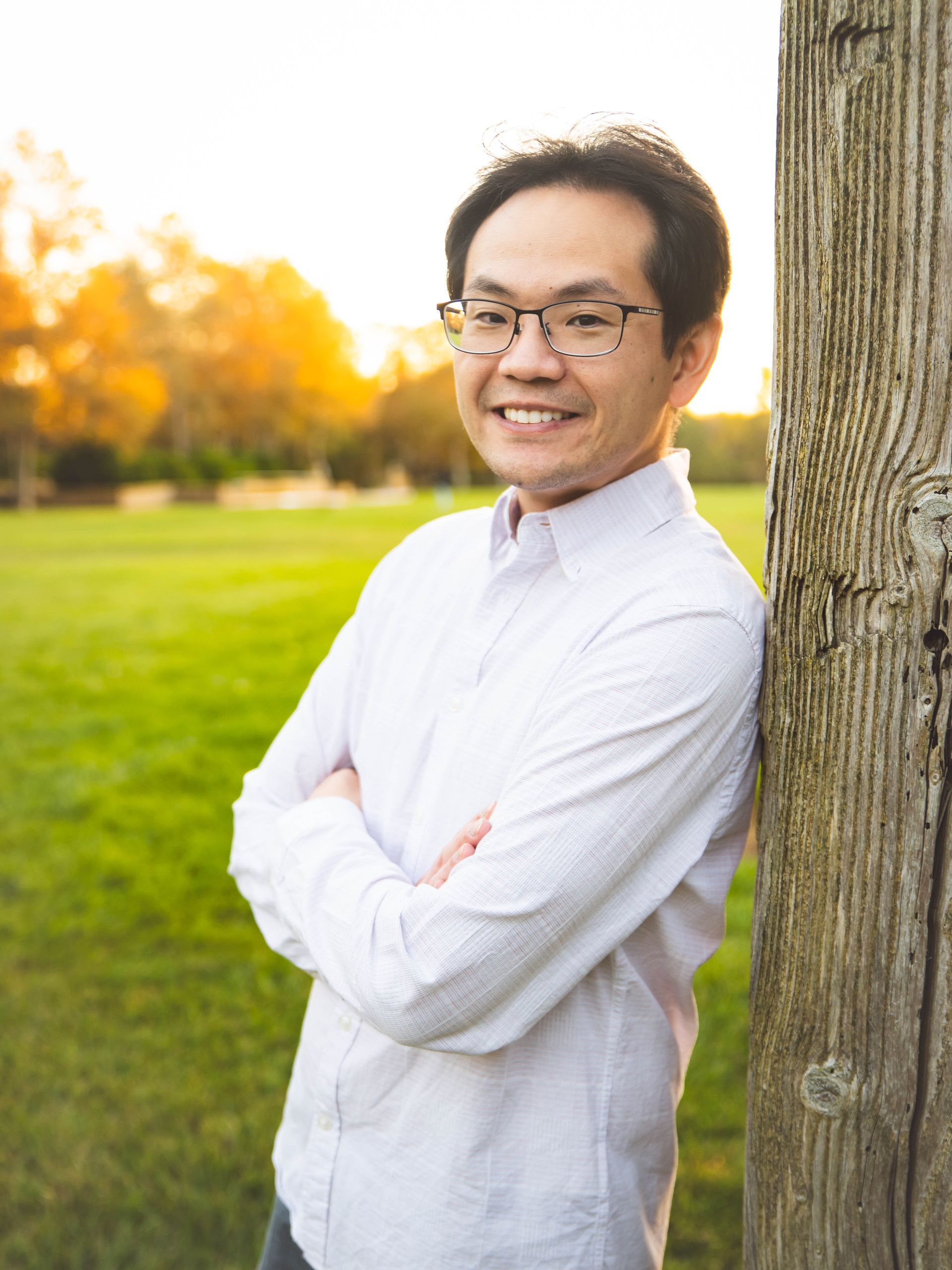 A man in a suit and tie is smiling for the camera