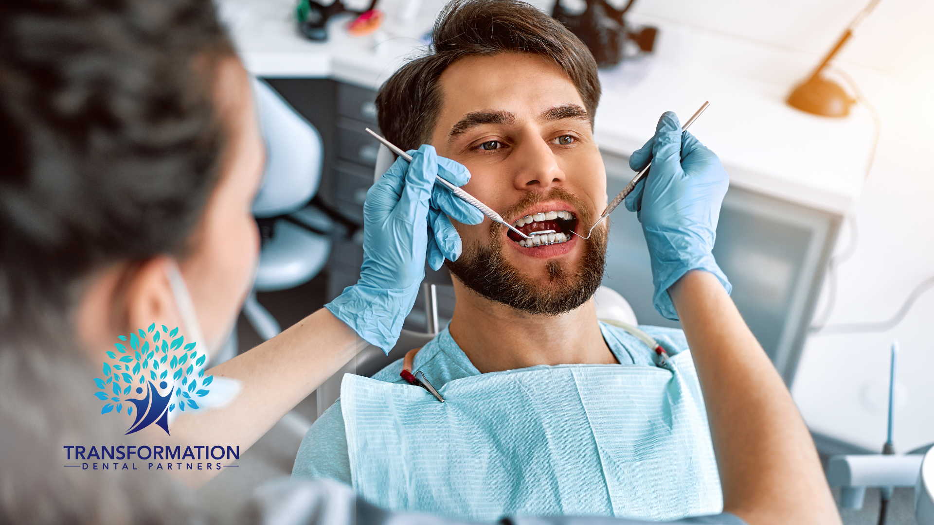 A man is getting his teeth examined by a dentist.