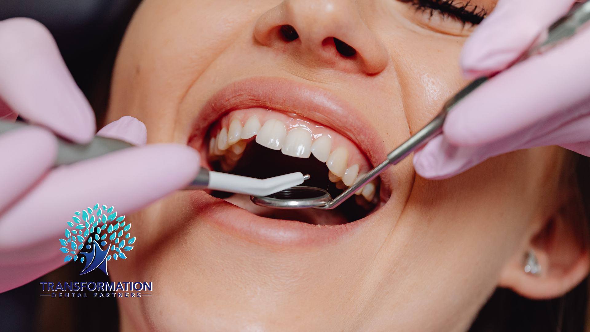 A woman is getting her teeth examined by a dentist.