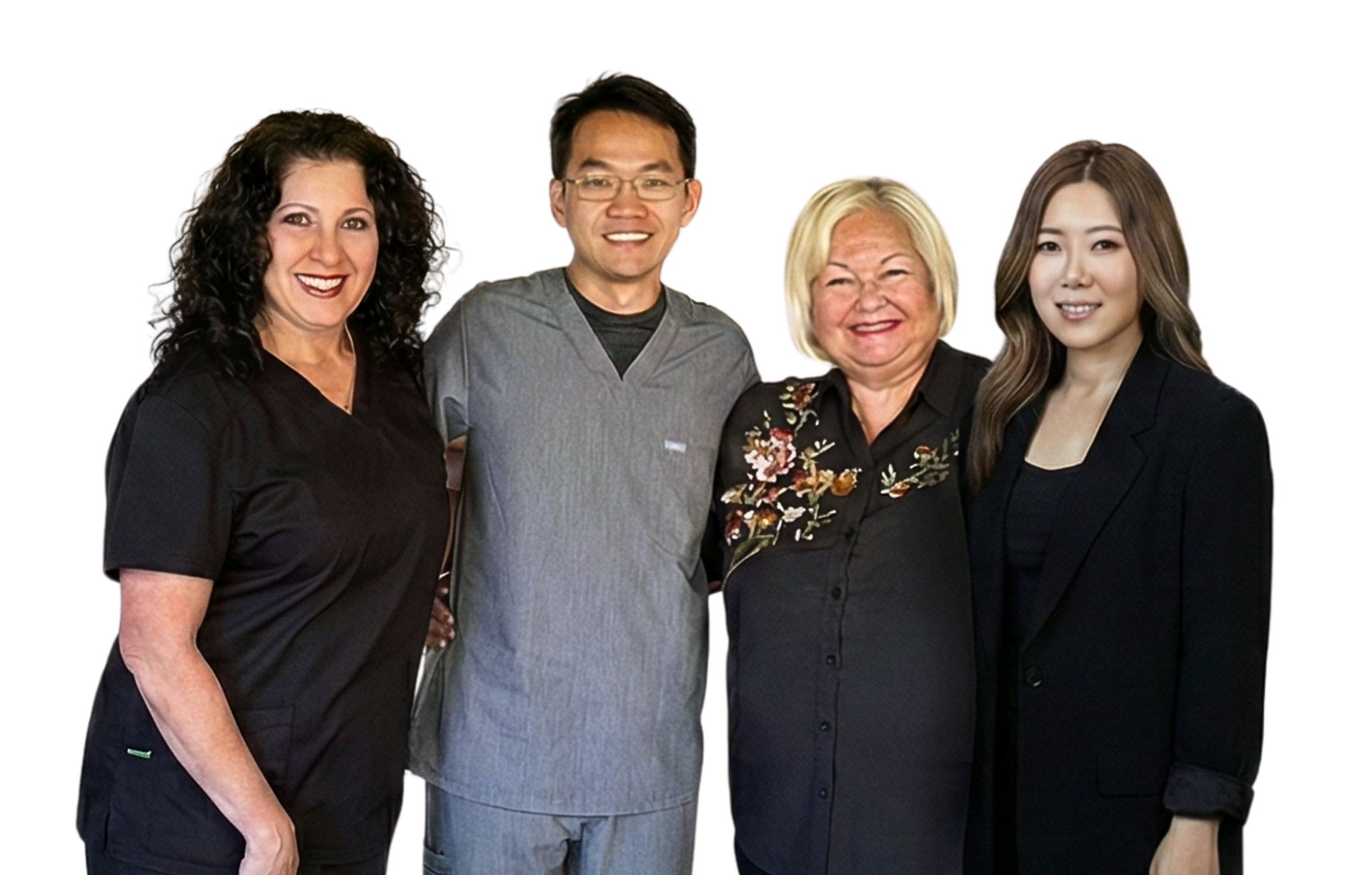 A group of people posing for a picture in front of a brick wall