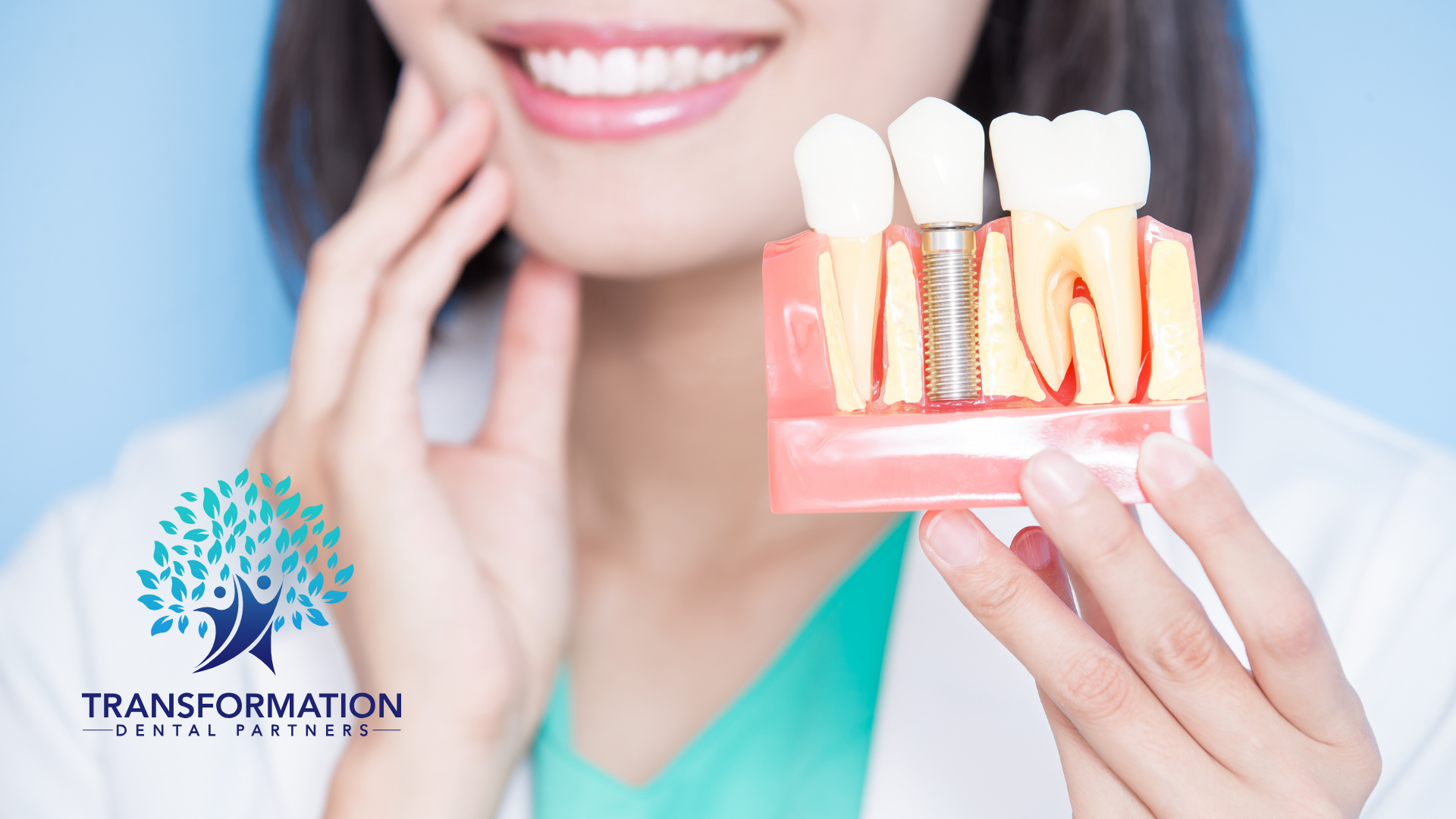 Woman smiling, holding dental implant model showing tooth replacement process.