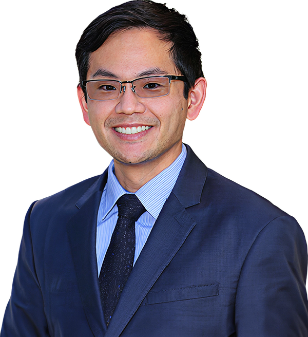 A man in a suit and tie is smiling for the camera