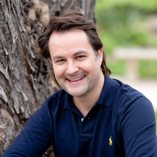 A man in a blue polo shirt is smiling