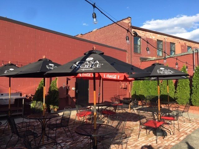 A patio with tables and chairs and coca cola umbrellas