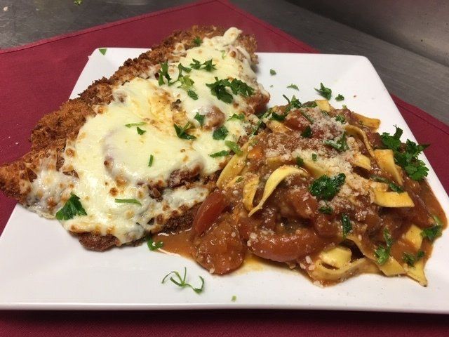 A plate of food with meat and noodles on a table