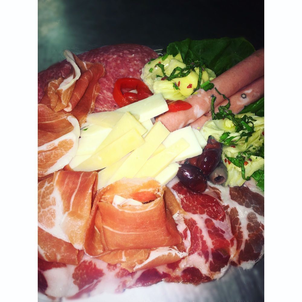 A close up of a plate of meat and cheese