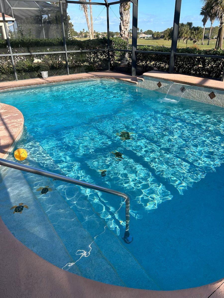 A large swimming pool with a fence around it