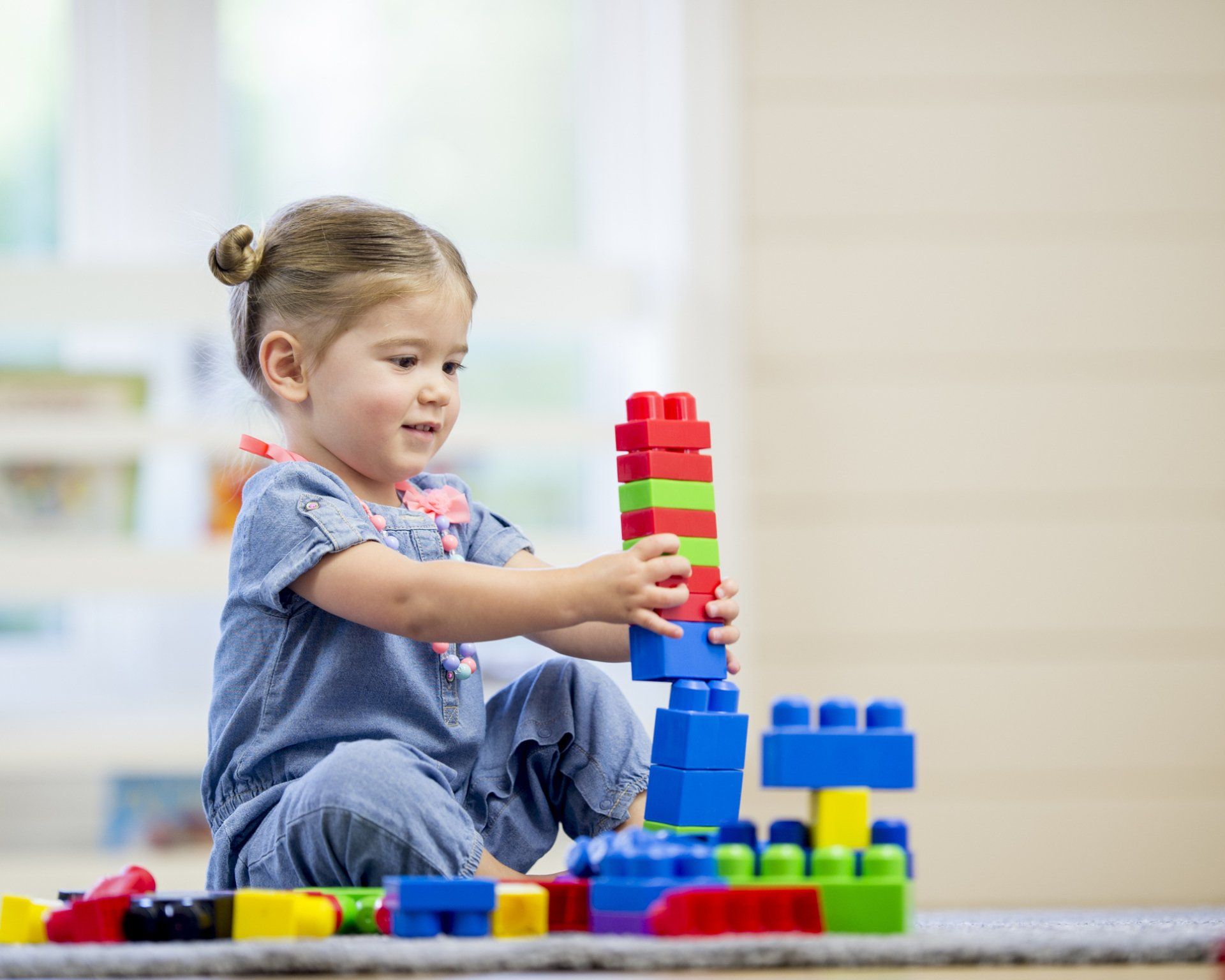 Baby Playing With Large Legos — Jacksonville FL — Crest Peak Learning Center