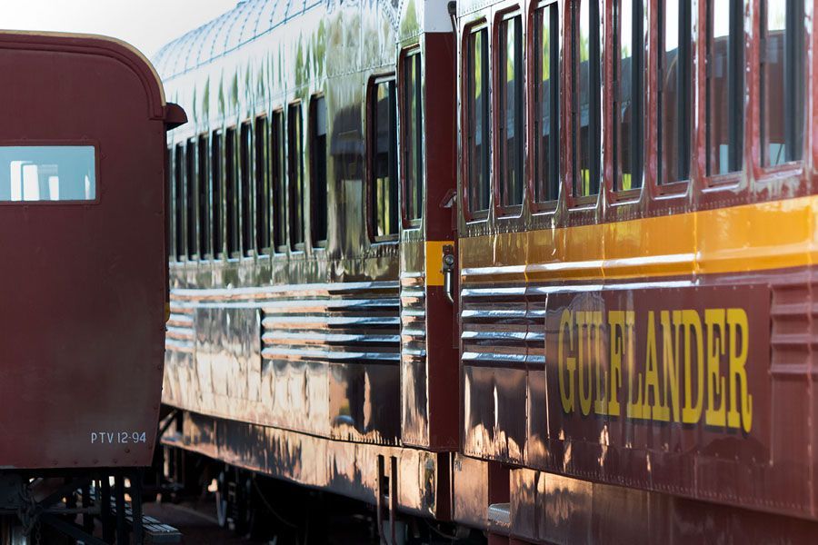 Vintage passenger train car, maroon and gold, 
