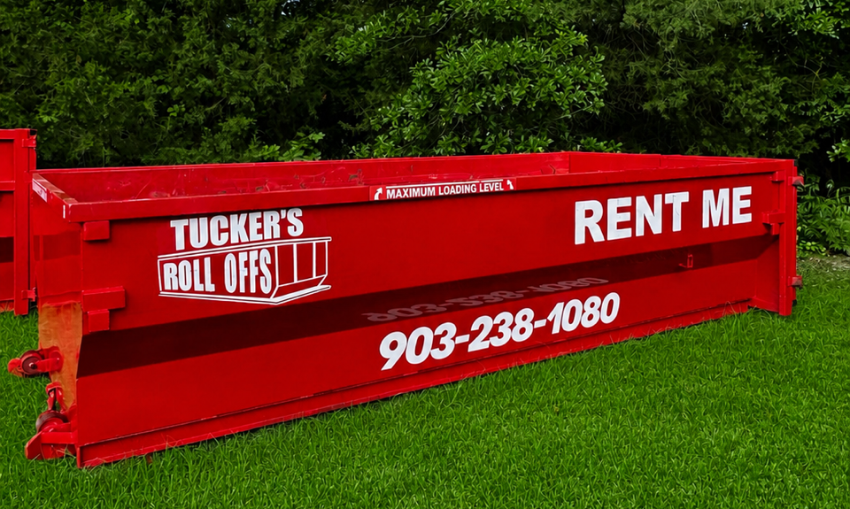 Red dumpster overflowing with torn cardboard and paper debris