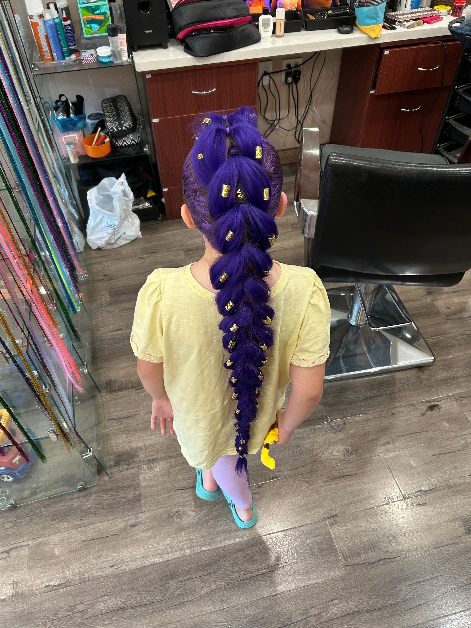 Boy with spiky blonde hair and a faded haircut, wearing a gray graphic tee.