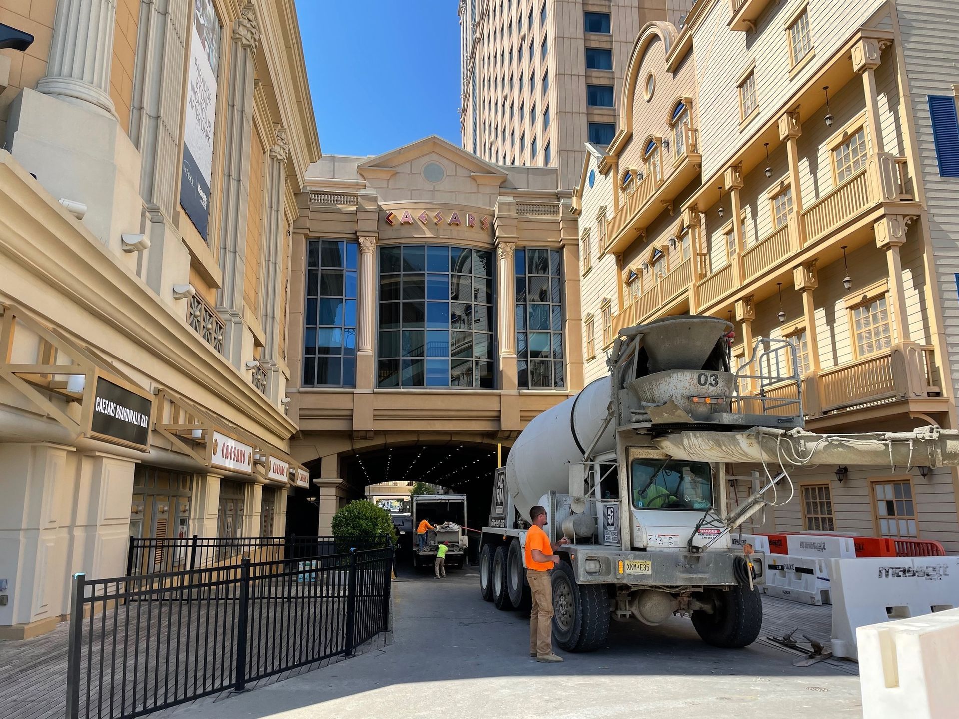 A concrete truck is parked in front of a building.