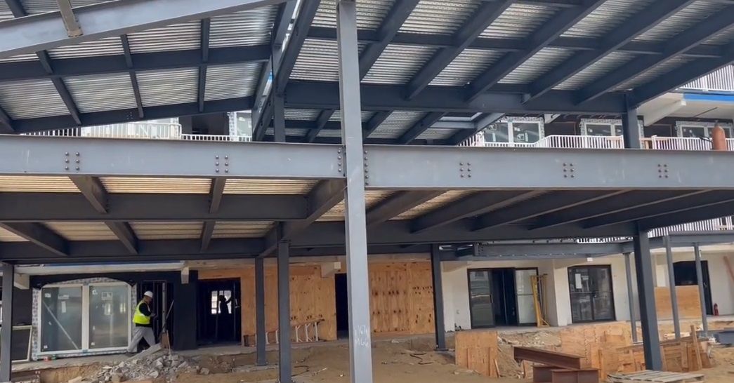 A large building is being built with a lot of steel beams.