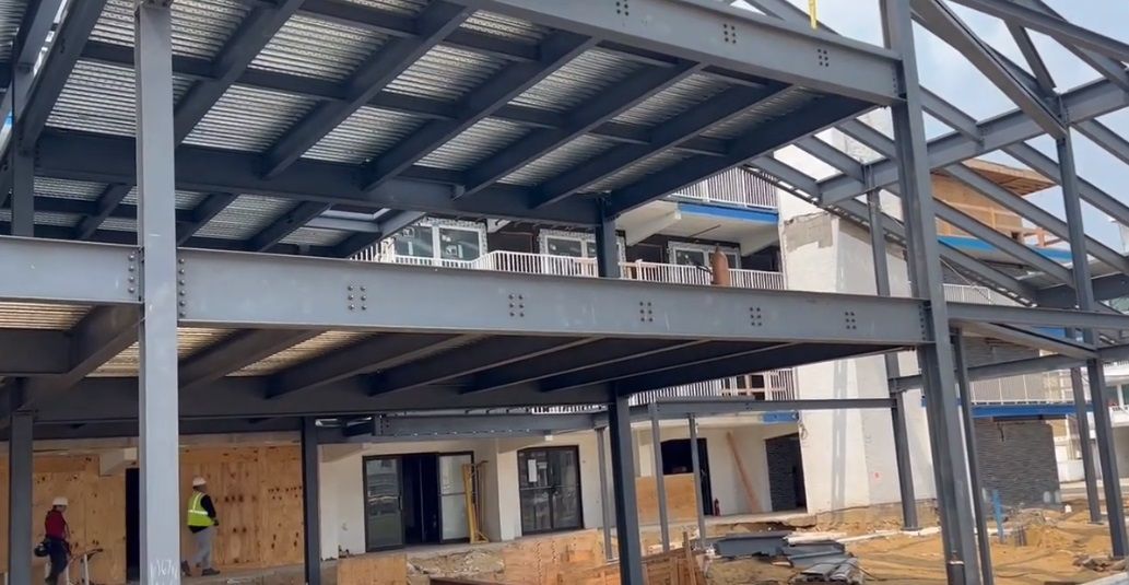 A large building is being built with a metal structure.