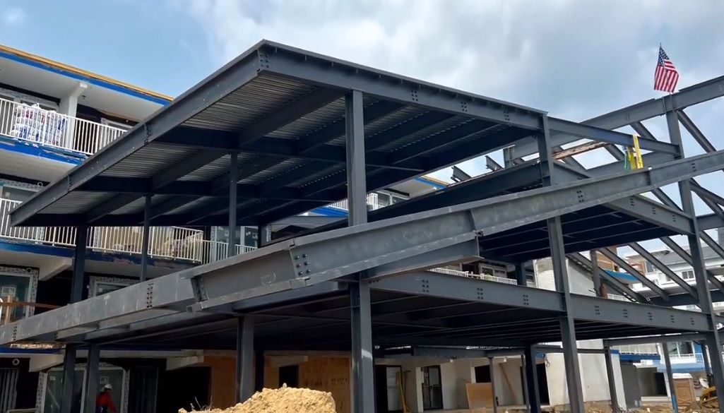 A large building is being built with a lot of steel beams.