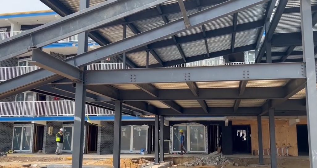 A building under construction with a metal structure and stairs.