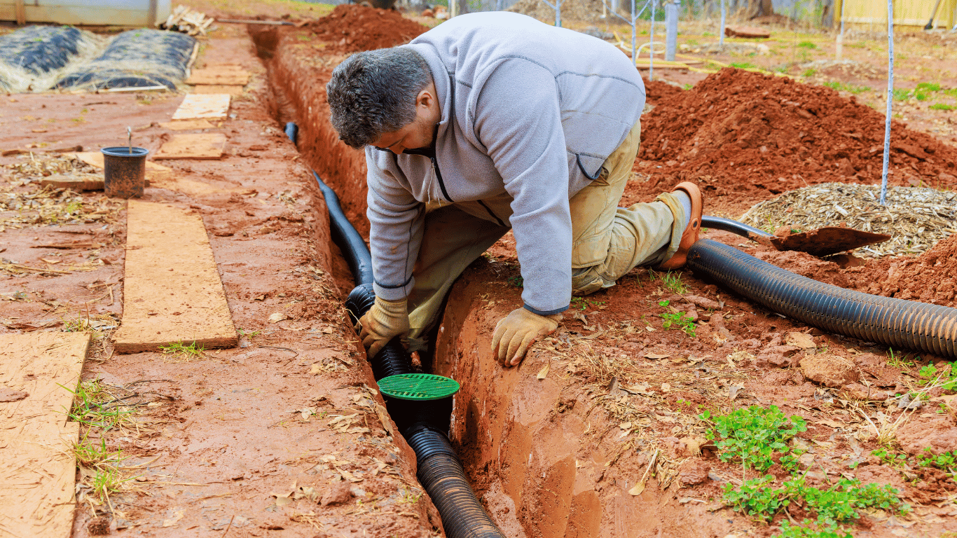 A person is pumping a hose into a septic tank.