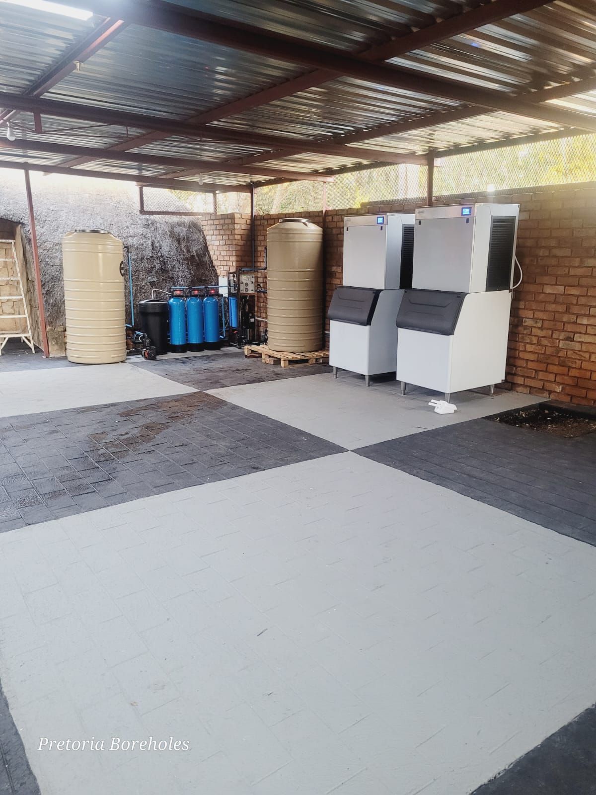 A warehouse with a lot of containers and water filters.