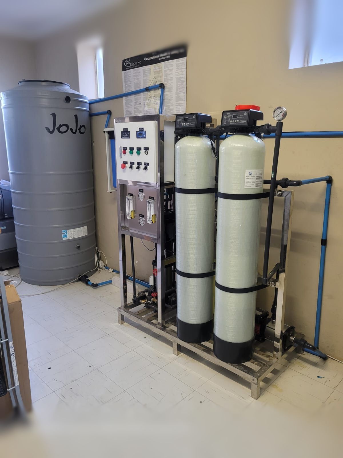 A room with two water tanks and a water filter.