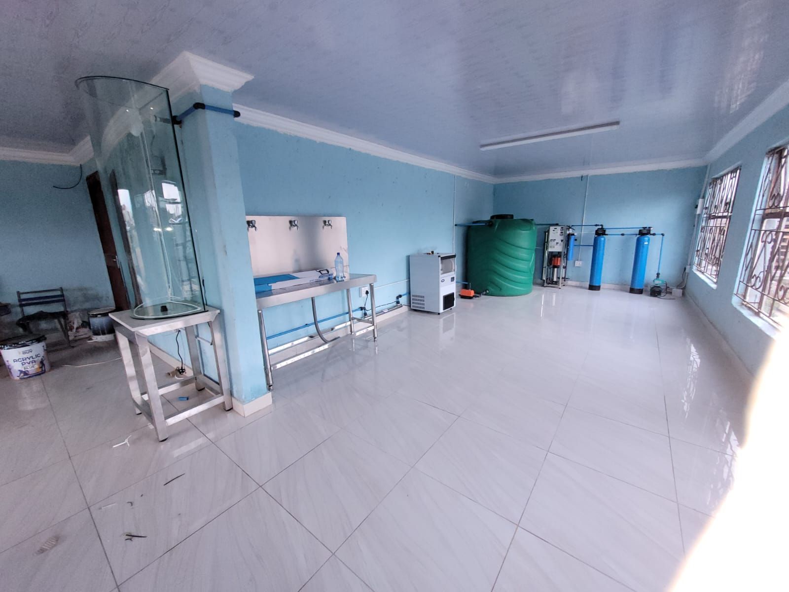 A large room with a lot of windows and a sink.