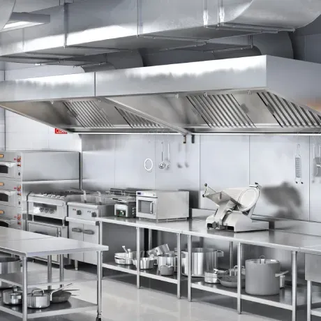 A kitchen with stainless steel appliances and a meat slicer