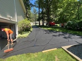 Person Is Using Broom To Spread Asphalt - Worcester, MA - Patriot Seal Coating & Paving