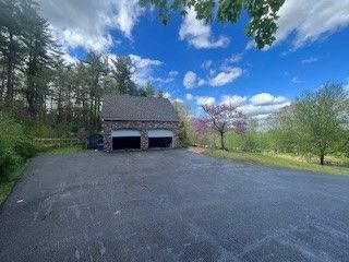 Black Asphalt Driveway Going Through Park With Trees - Worcester, MA - Patriot Seal Coating & Paving