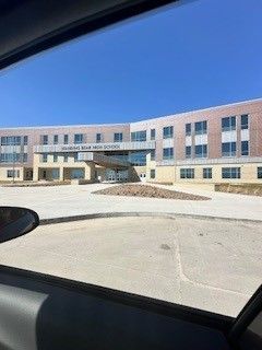 Exterior of Heartland High School on a sunny day with a clear blue sky.
