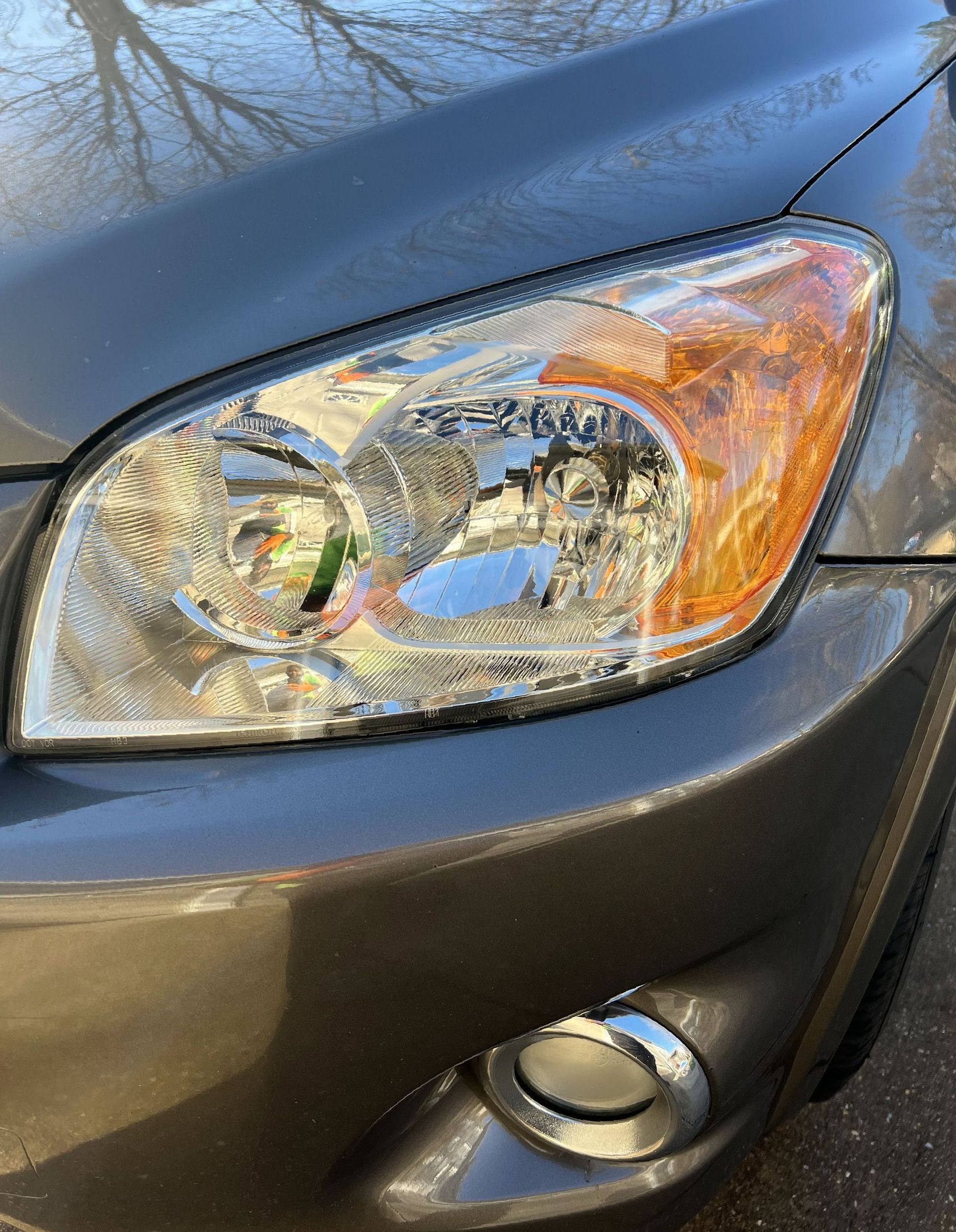 a close up of a car 's headlight on a street .