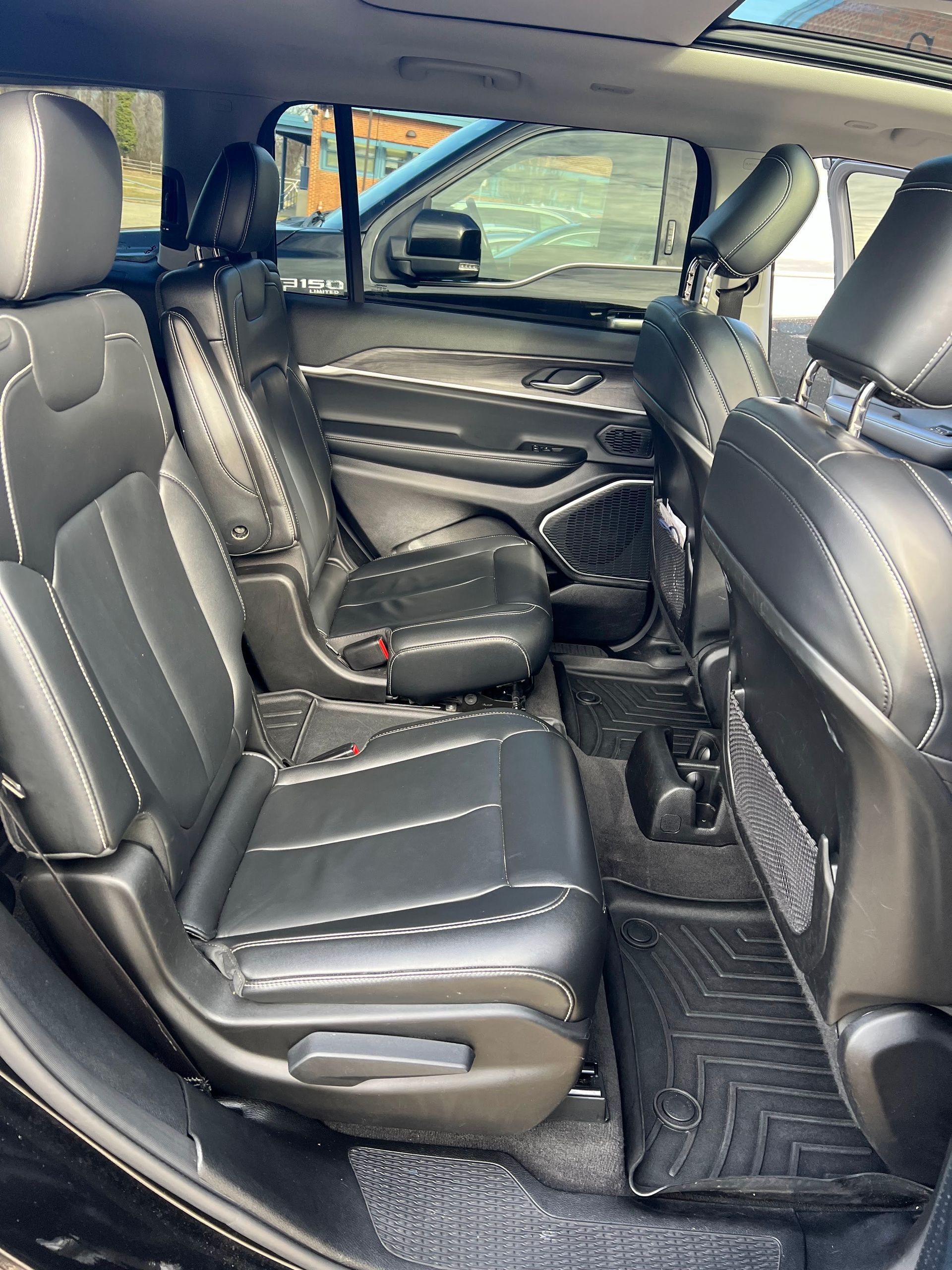 the back seat of a black jeep compass with a sunroof .