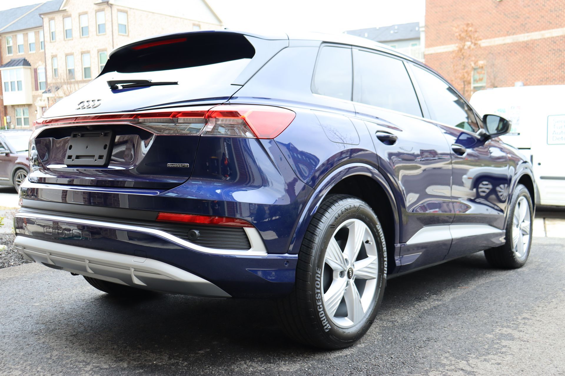 a blue car is parked in front of a brick building .