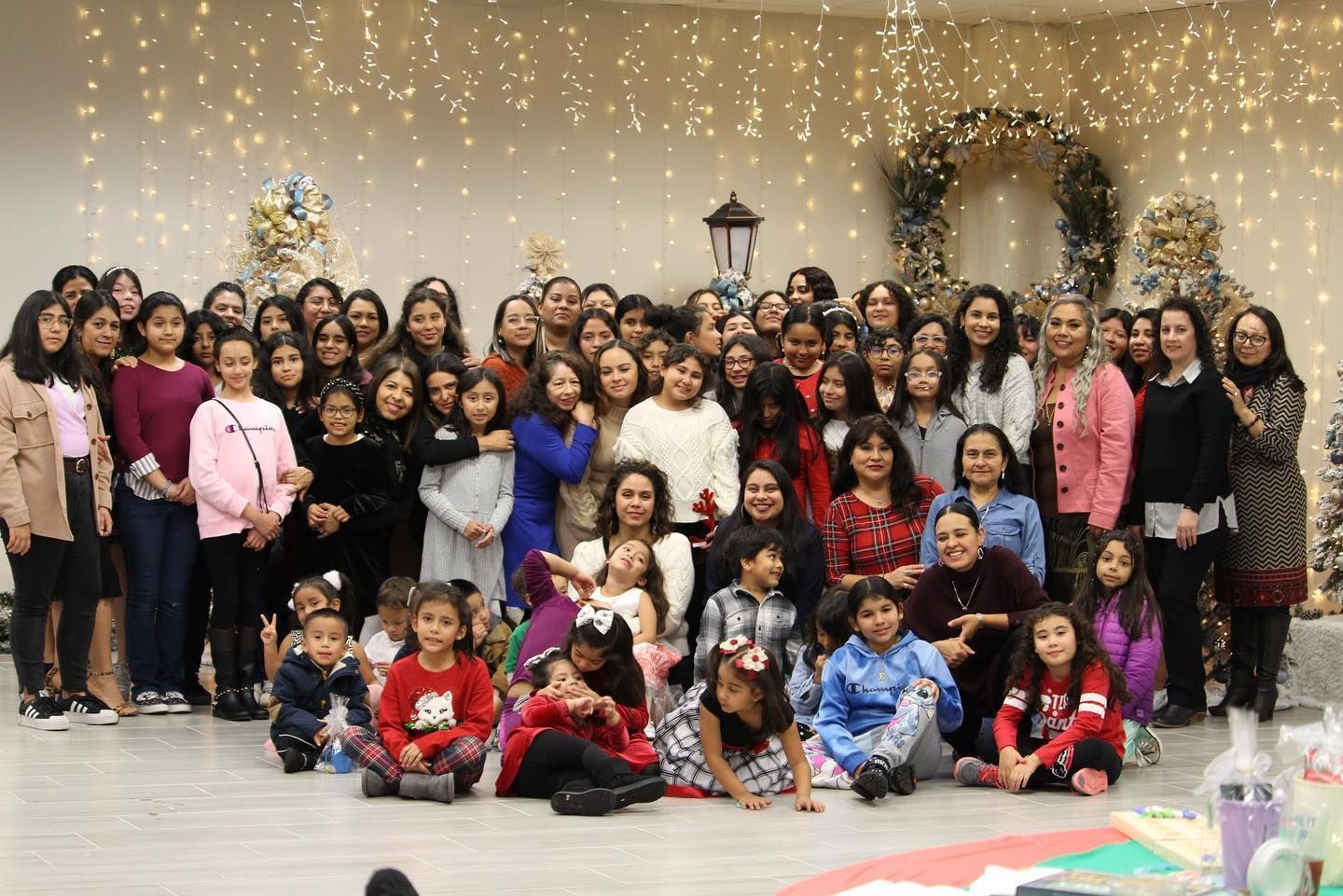 A group of people are sitting in a circle holding hands.