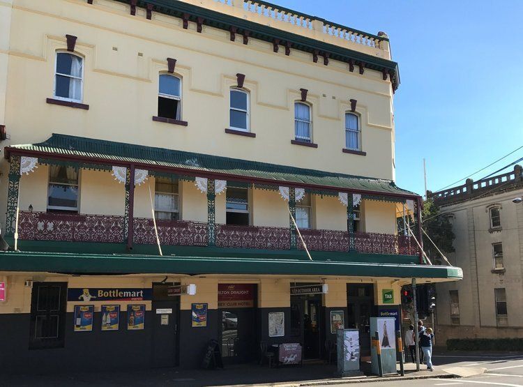 Large Yellow Building With A Green Awning — CPAINT in Forster, NSW