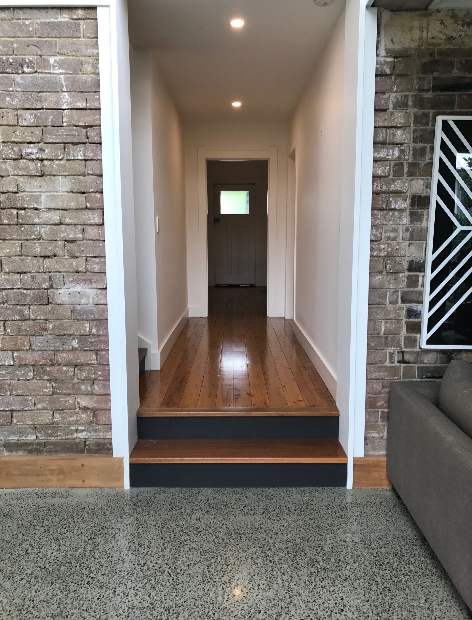 Hallway With Wooden Floors And Stairs Leading To A Door — CPAINT in Forster, NSW