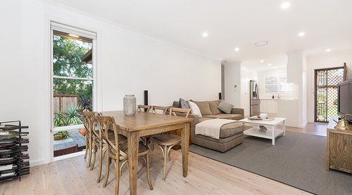Living Room With A Dining Table And Chairs And A Couch — CPAINT in Forster, NSW