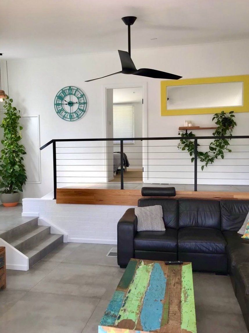 Living Room With A Couch And A Ceiling Fan — CPAINT in Forster, NSW
