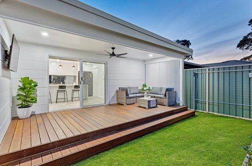 Backyard Of A House With A Wooden Deck And A Sliding Glass Door — CPAINT in Forster, NSW