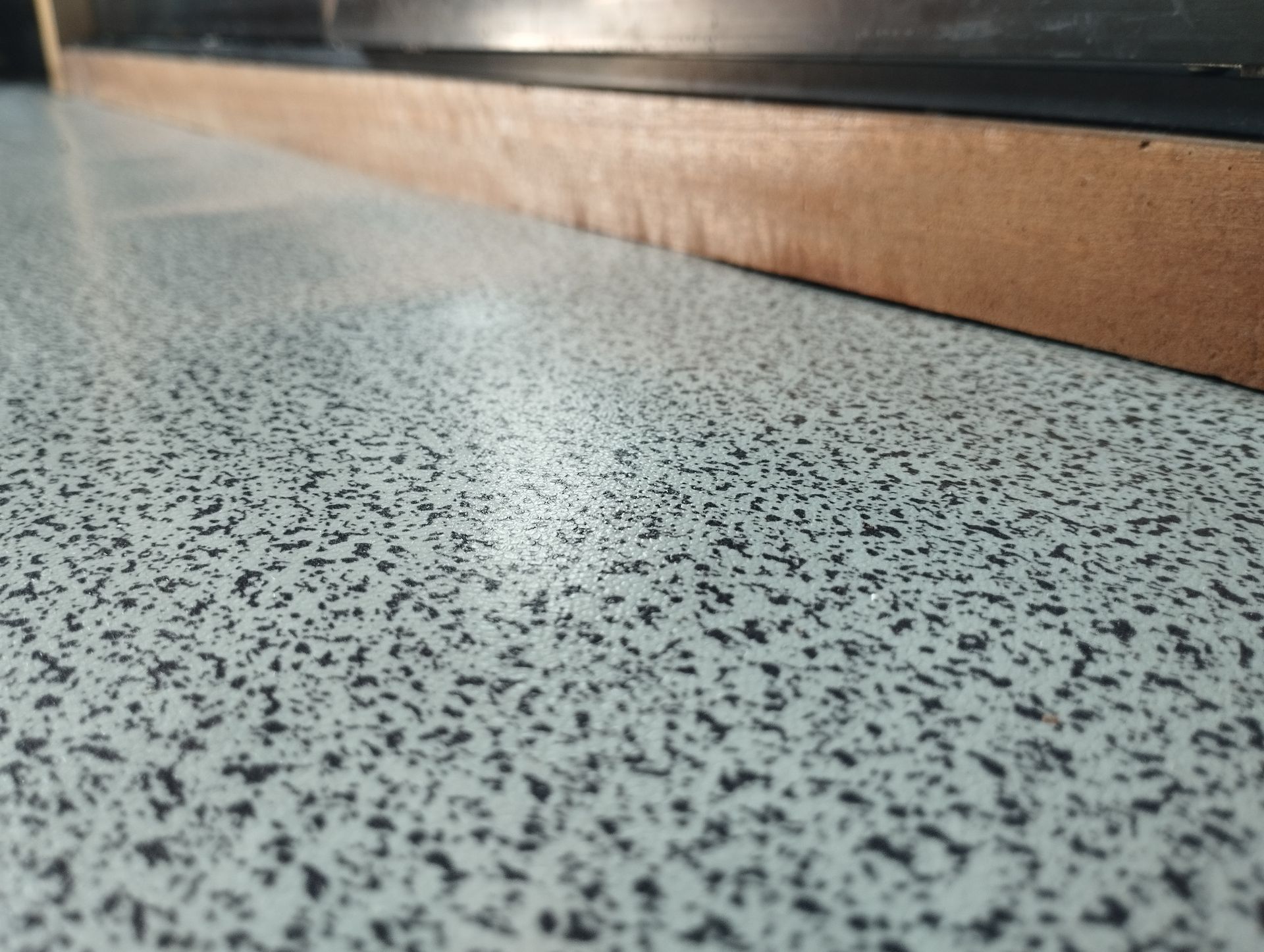 Granite-Like Countertop Texture With A Wooden Edge Visible; A Slightly Blurred View — CPAINT In Kempsey, NSW