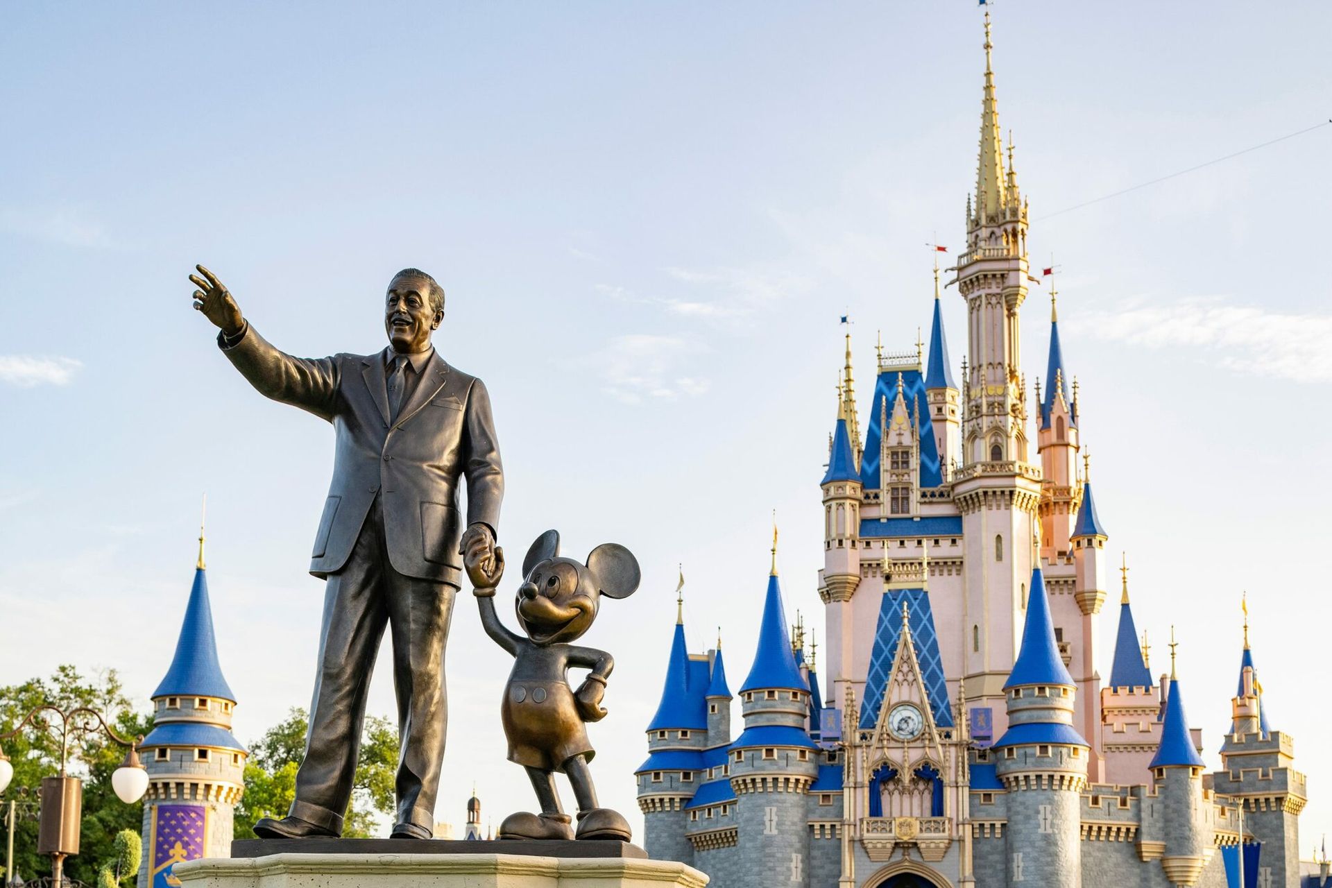 Statue of Walt Disney with Mickey Mouse, in front of Cinderella Castle at Disney World.