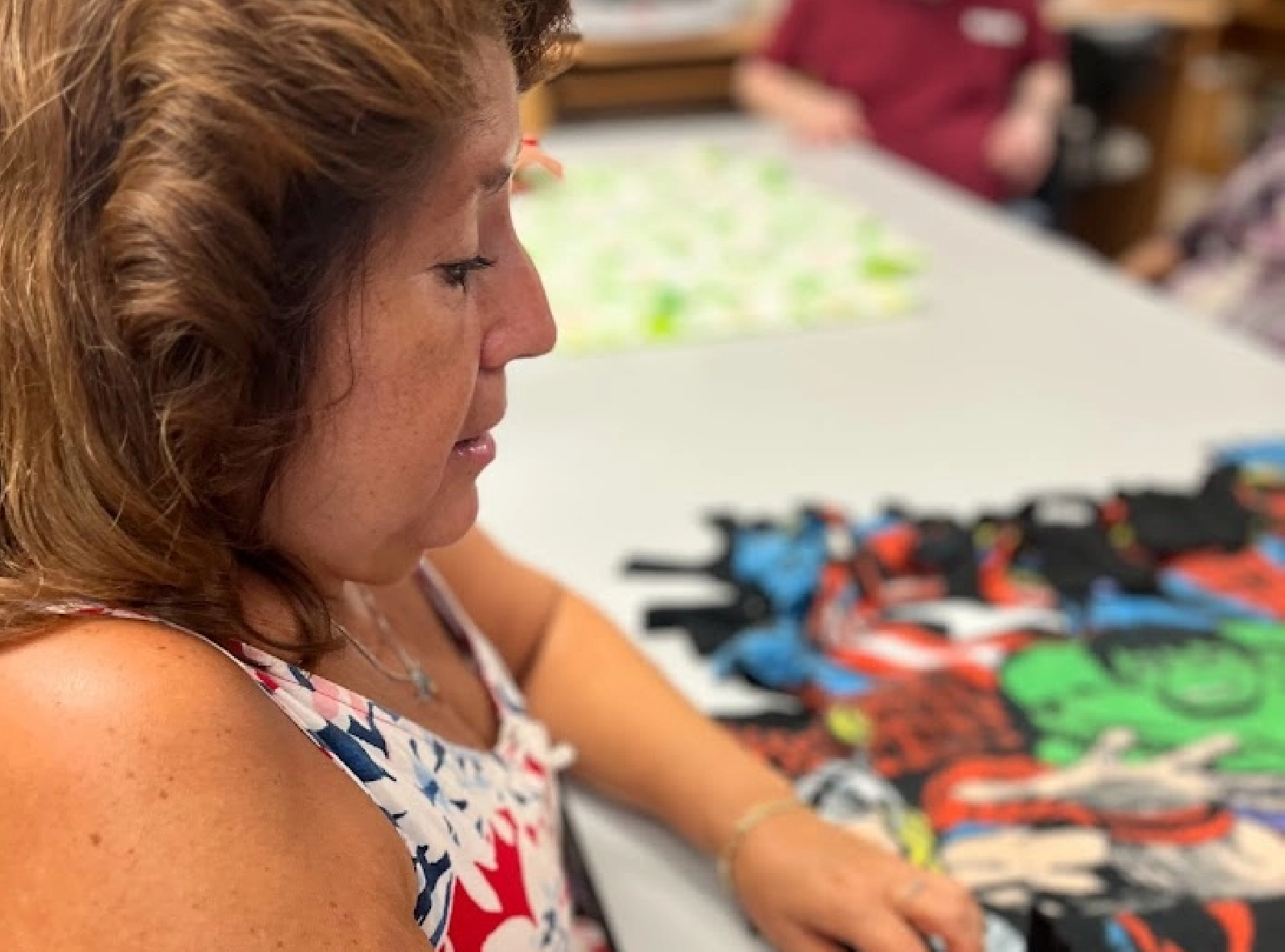brunette visually impaired woman working on art project