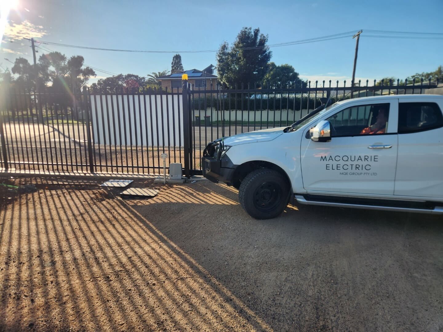 Two Men Are Sitting at a Table With Laptops — Macquarie Electric in Dubbo, NSW