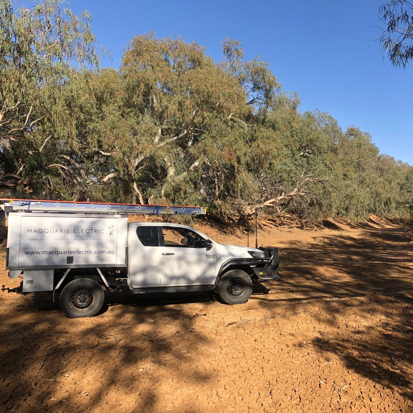 A Man is Working on an Electrical Panel — Macquarie Electric in Dubbo, NSW