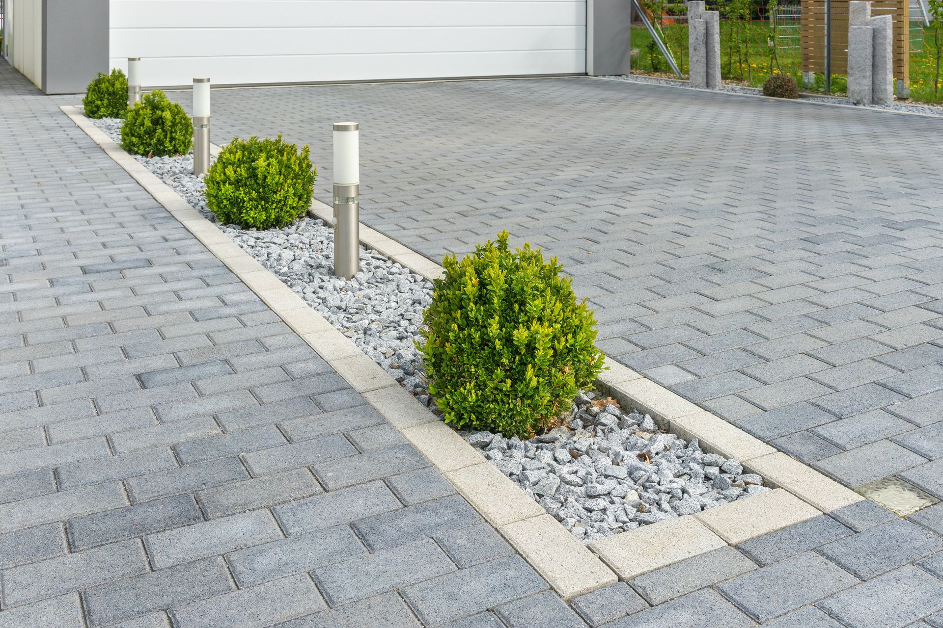 Bricked concrete driveway with a textured pattern for added visual appeal and traction.