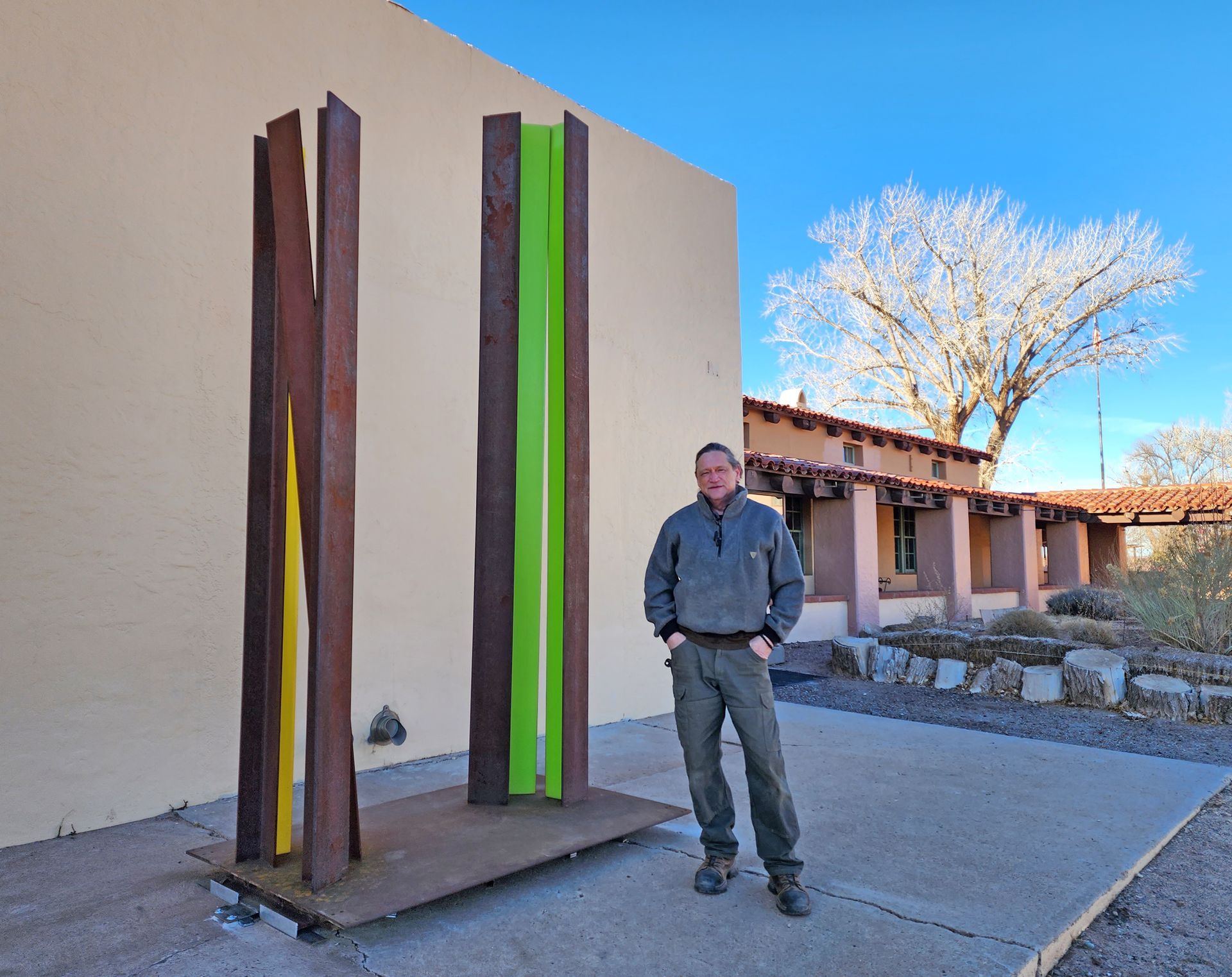 A man standing next to a sculpture