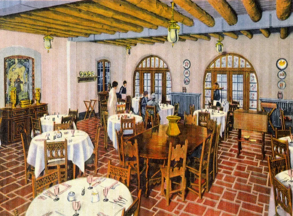 Restaurant interior with tables, chairs, arched doorways, and servers. Red brick floor, light pink walls, and wood beams.