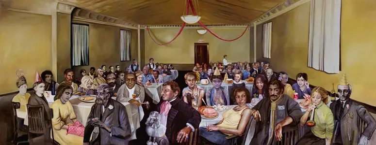 Large room with a gathering of people seated at long tables. Red ribbons hang from the ceiling.