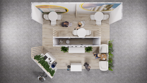 Overhead view of a trade show booth with tables, seating, and displays; several people are present.