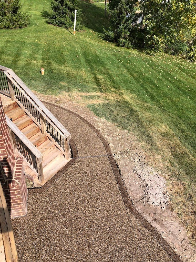 A wooden staircase leading up to a lush green lawn.