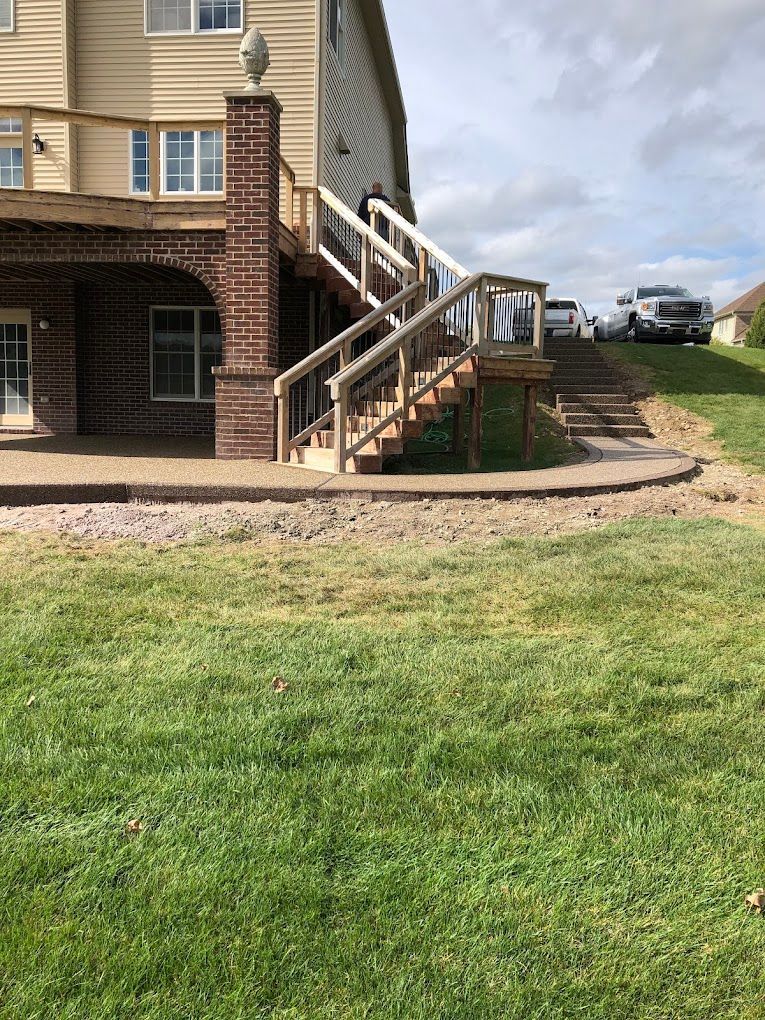 A house with a deck and stairs leading up to it.