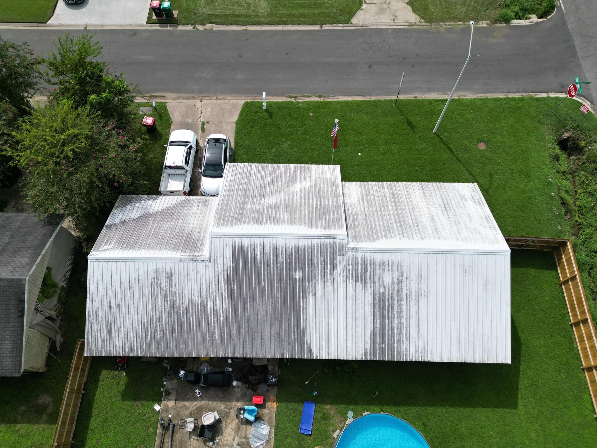 An aerial view of a house with a pool in the backyard.